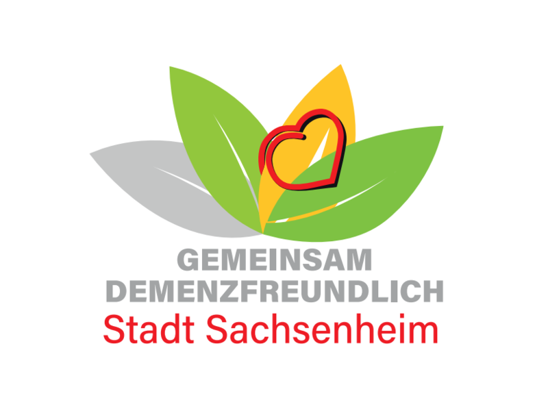 Das Bild zeigt ein Logo mit bunten Blättern, einem roten Herz und dem Text "Gemeinsam Demenzfreundlich Stadt Sachsenheim".